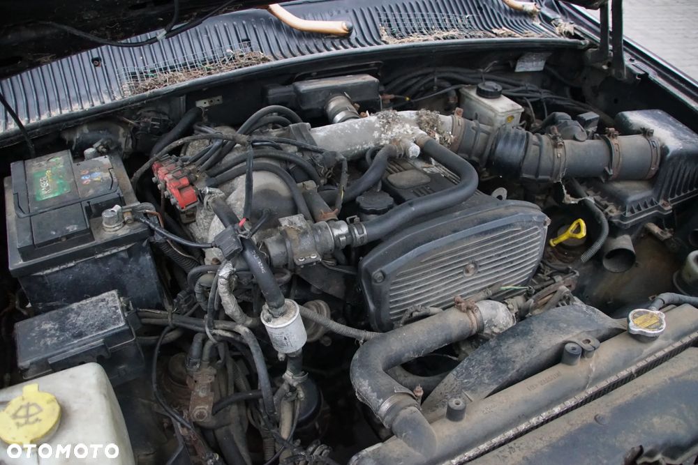 Auto na części - Kia Sportage I 2.0 DOHC 128 KM 4x4 1997R Silnik Skrzynia Drzwi Maska Klapa Drzwi Błotnik Zderzak Szyba Lusterko Klamka Lampa Deska Kokpit Sterownik Moduł Czujnik Licznik Panel - 18