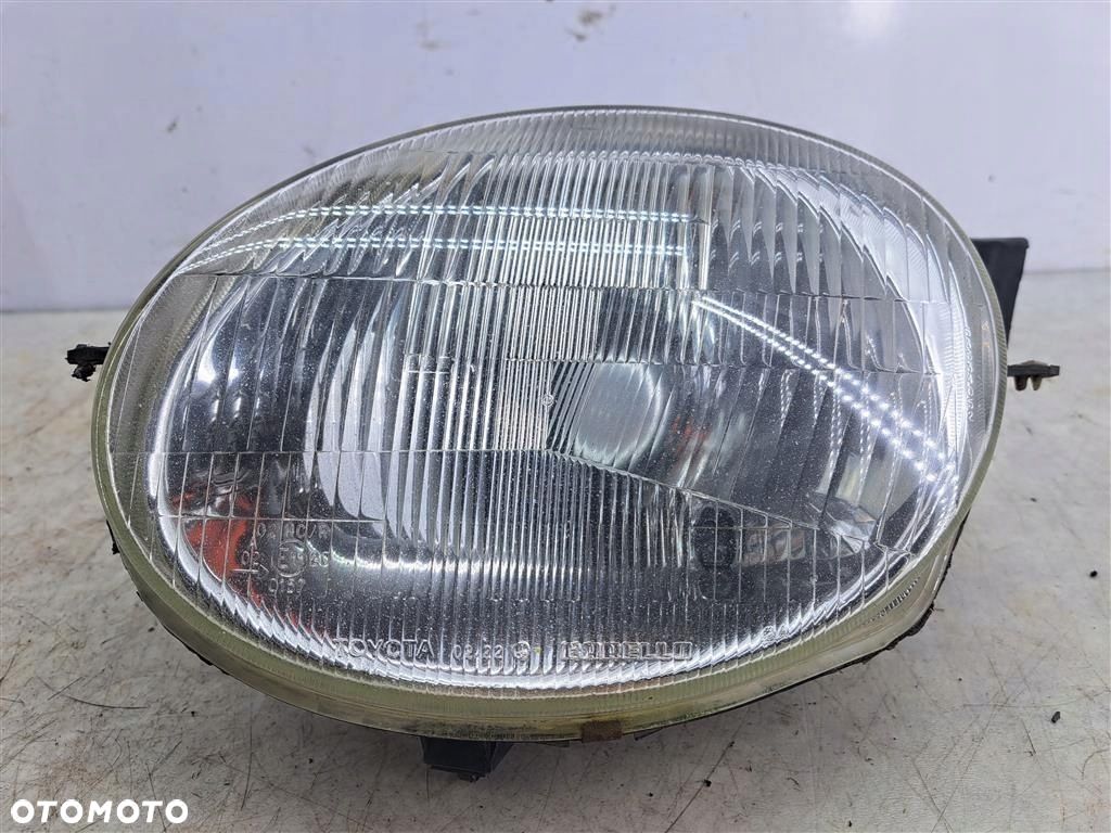 Reflektor lampa przód lewa Toyota Corolla 8 VIII E11 97-99 CARELLO EU - 1