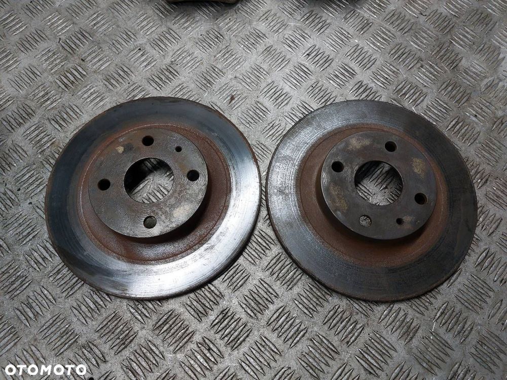 TARCZE HAMULCOWE TYŁ + KLOCKI + ZACISKI MAZDA 323F BJ 2.0 TD - 2