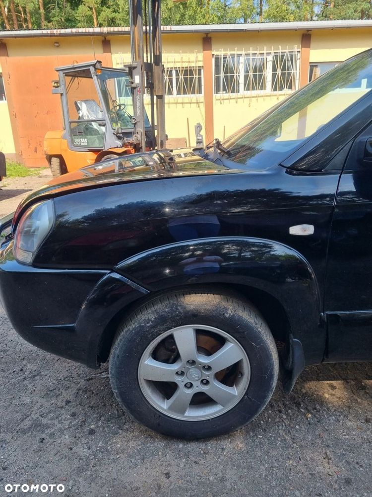 HYUNDAI TUCSON I 04-10 2007 r. EB BŁOTNIK LEWY PRZÓD LP Z LISTWĄ - 2