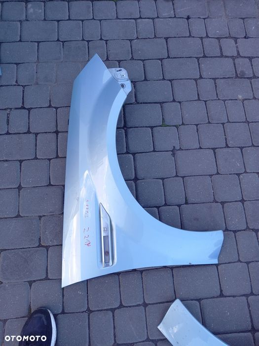 Blotnik przedni lewy opel tigra b 2008r lakier z21y bez korozji