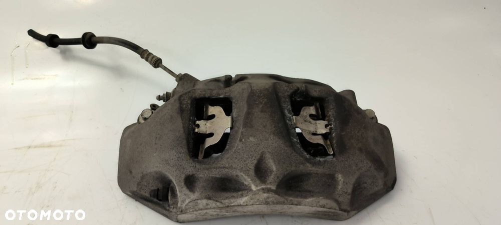 ZACISK HAMULCOWY PRZÓD LEWY AUDI Q7 II 4M 4M0615105 - 1