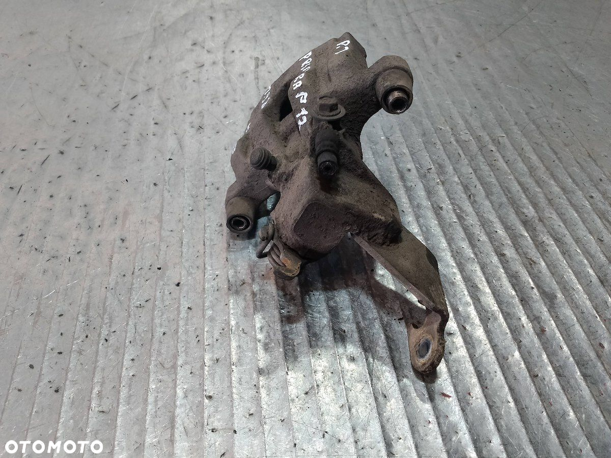 ZACISK HAMULCOWY PRAWY TYŁ NISSAN PRIMERA P12 1.9 - 6