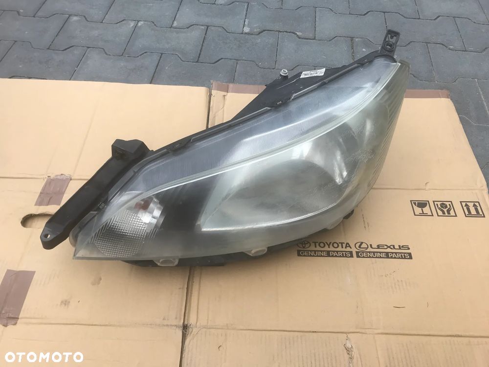 Nissan NV200 09-19 Lampa Reflektor Lewy Przód 26060-BJ10A - 1