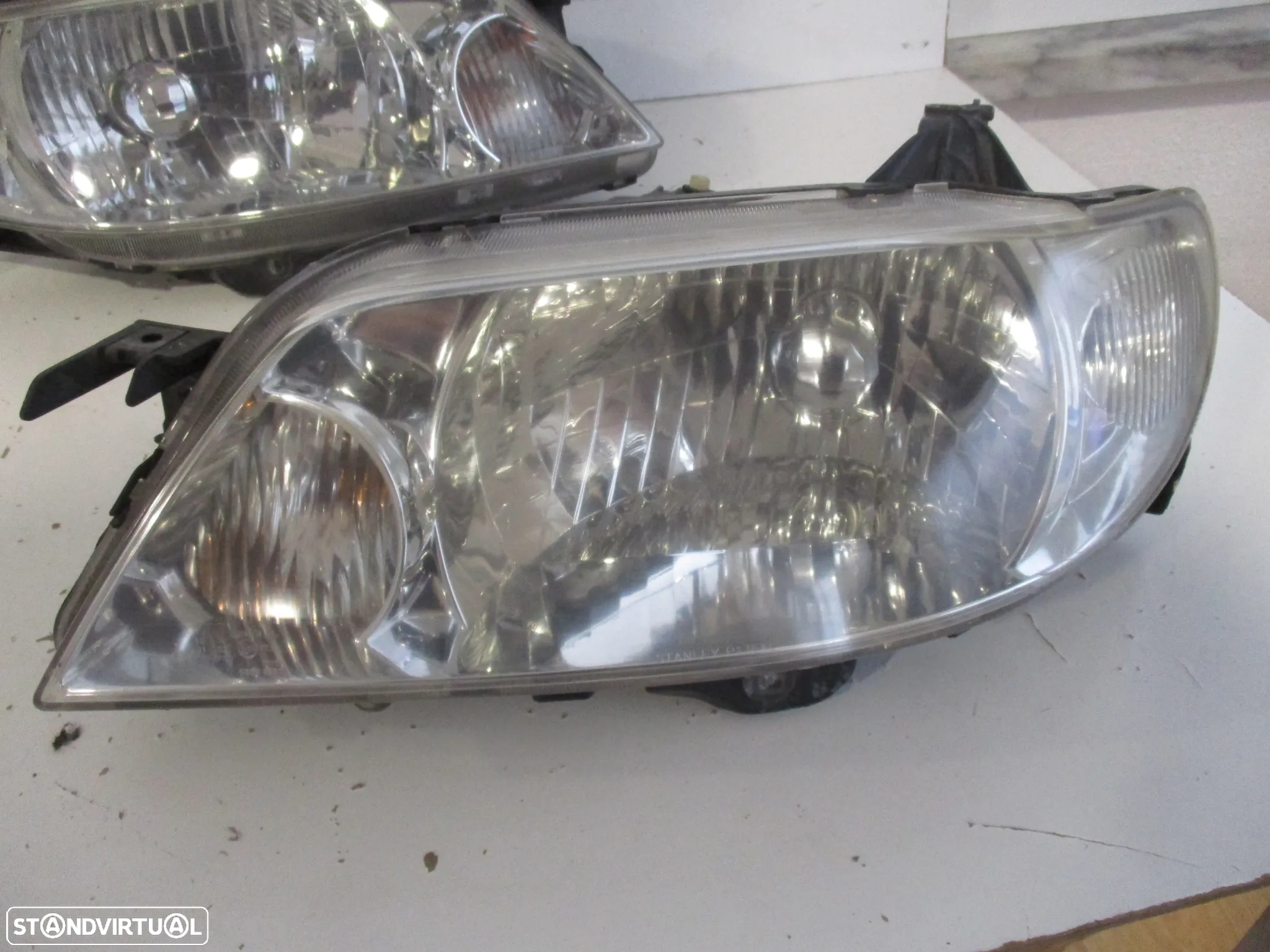 farol optica mazda 323F 2000 - 2