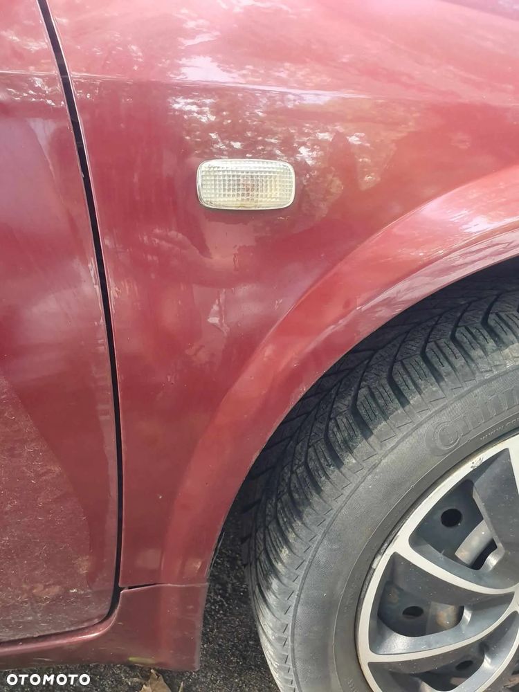 Nissan Primera  P12 HB Błotnik lewy,prawy. - 4