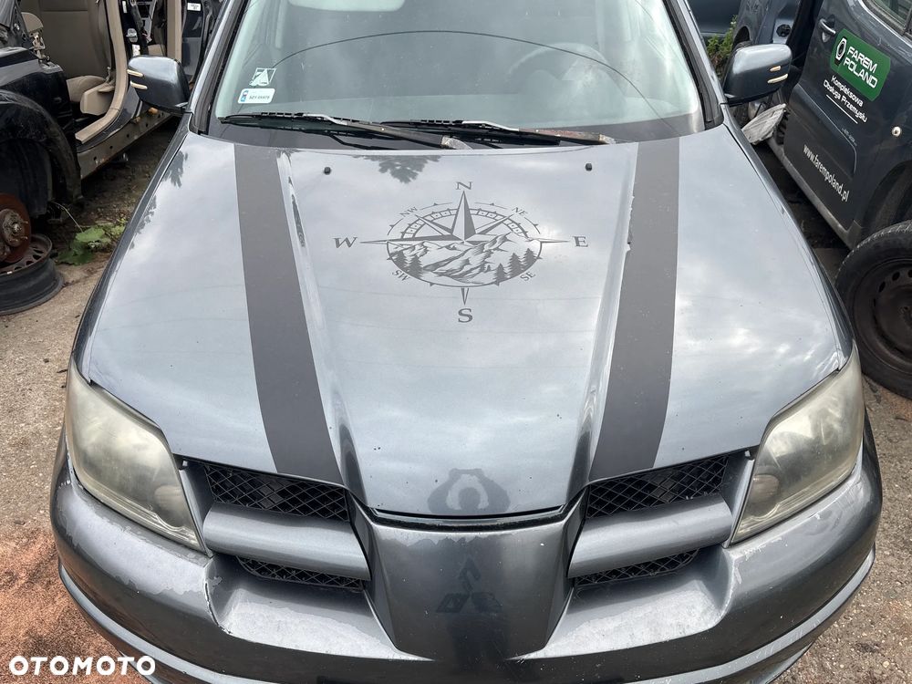 MASKA MITSUBISHI OUTLANDER 2003R LAKIER T12 - 1
