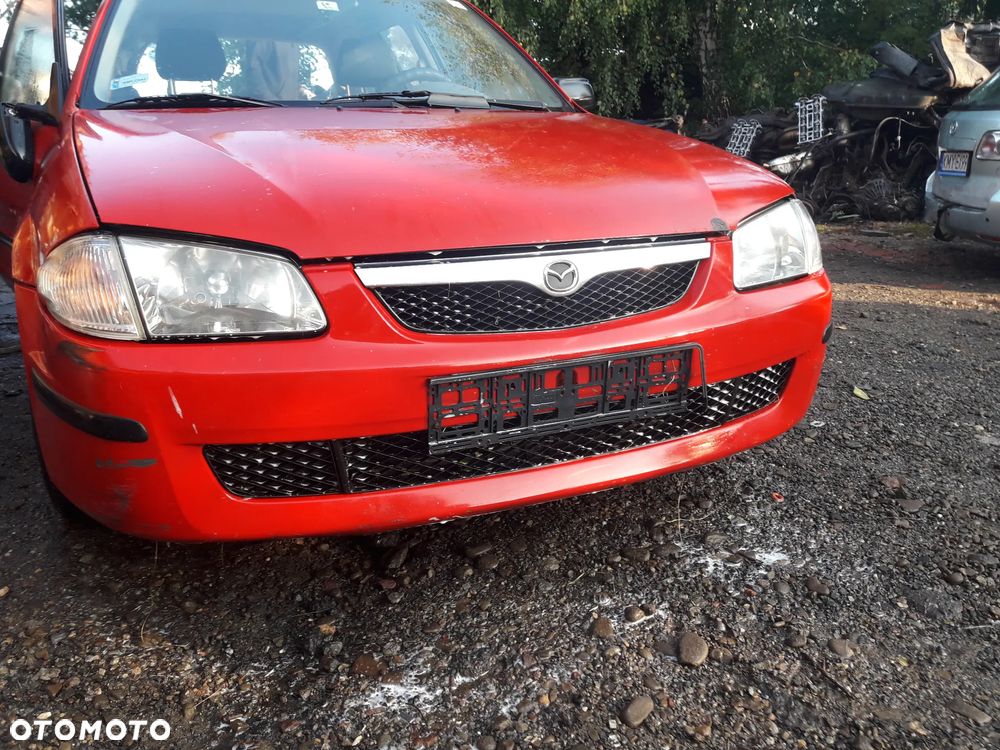 Mazda 323 323f 323  BJ 98-03  Maska lampa zderzak pas zamek w kolor SU - 2