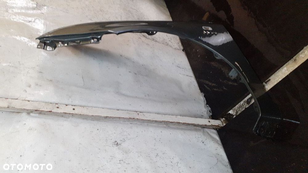* TOYOTA COROLLA E12  BŁOTNIK PRZÓD LEWY 1G3 - 2