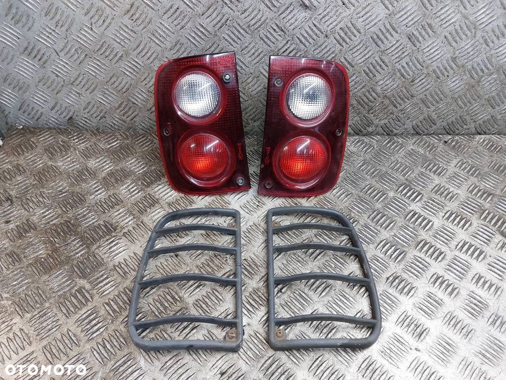 LAMPA LEWY TYŁ + PRAWY TYŁ KRATKI OSŁONY LAND ROVER FREELANDER I - 1