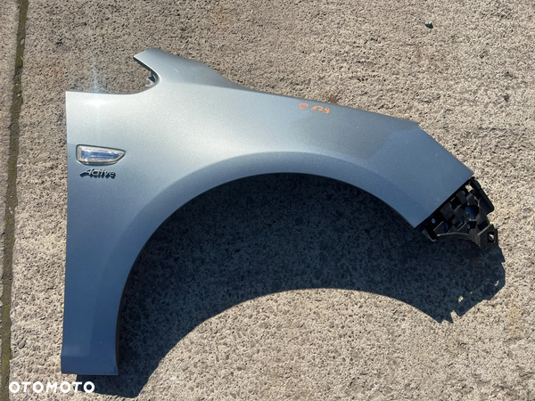 Błotnik przedni przód prawy Opel Astra J IV Z179