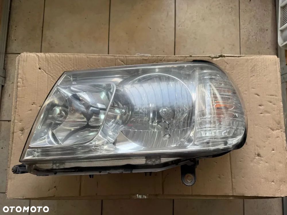 Reflektor / lampa przód przednia lewa Toyota Land Cruiser 100 LC100  - oryginalna - 1