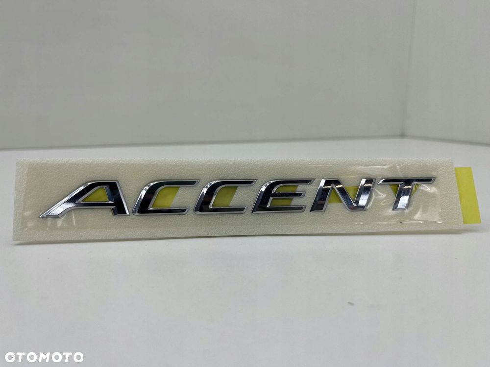 HYUNDAI ACCENT ZNACZEK EMBLEMAT LITERY MODELU 86311-H5000 - 1