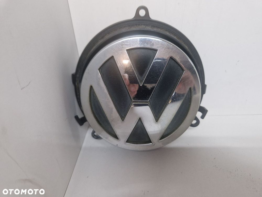 VW GOLF PASSAT B6  1K0827469E KLAMKA EMBLEMAT KLAPY BAGAŻNIKA