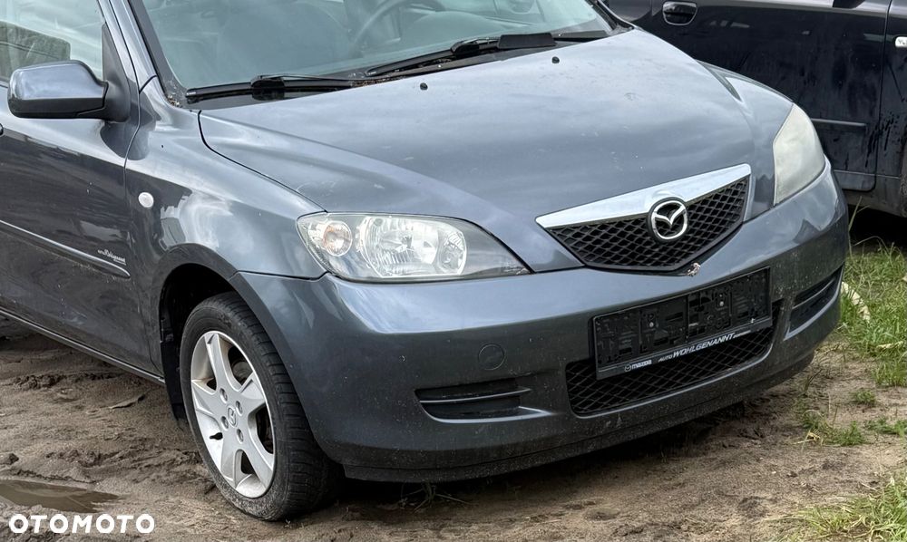 Mazda 2 DY 2003/2006r maska pokrywa silnika 27K  grill wygłuszenie maski belka chlapacze lampy wzmocnienie zderzak tył blotnik kmaska pokrywa silnika drzwi lampy tył  przed lift lub polift czy sport zaslepka Moduł przetwornica Xenon starter cewka ksenon zaslepka - 1