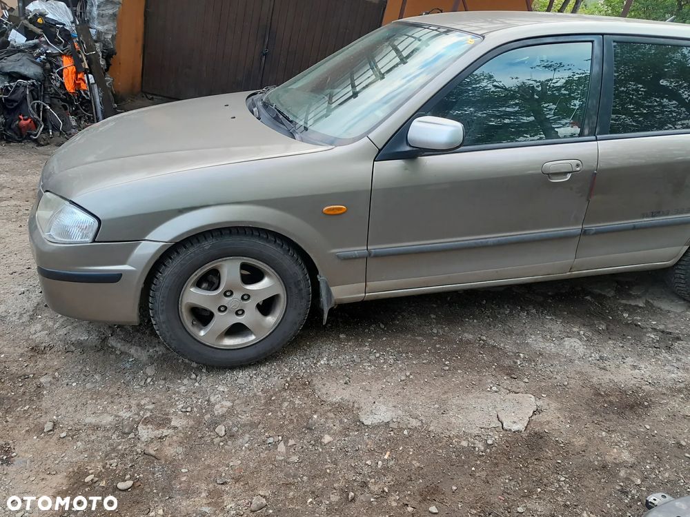 Mazda 323 323f BJ 98-03  Maska lampa zderzak pas atrapa 12M - 4