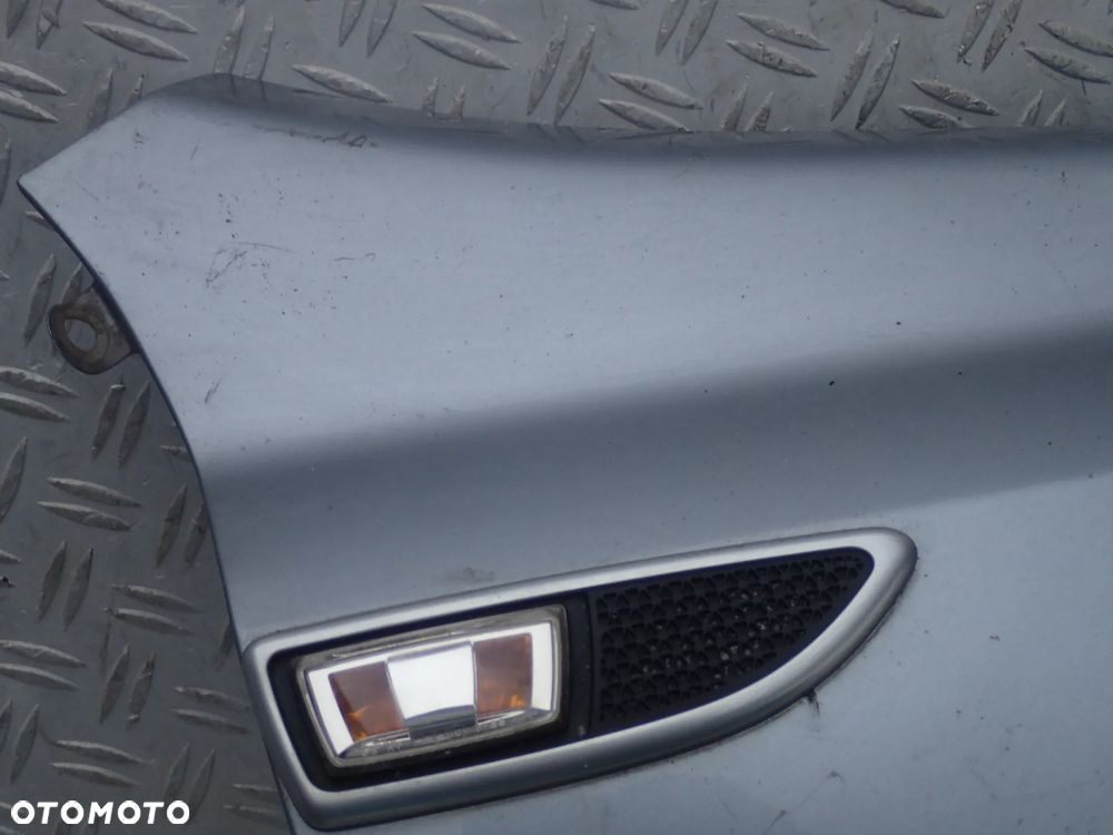 BŁOTNIK PRAWY PRZÓD OPEL ASTRA III - 2