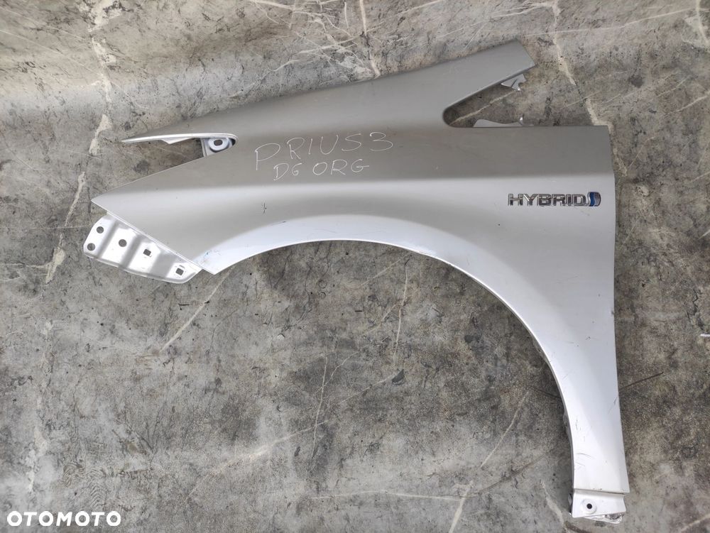 BŁOTNIK LEWY PRZÓD PRZEDNI TOYOTA PRIUS III SREBRNY ORG LAKIER 09-15