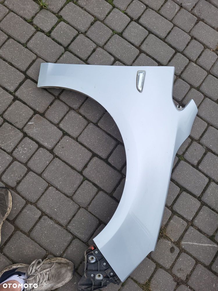 Błotnik przedni prawy opel astra j lakier z176
