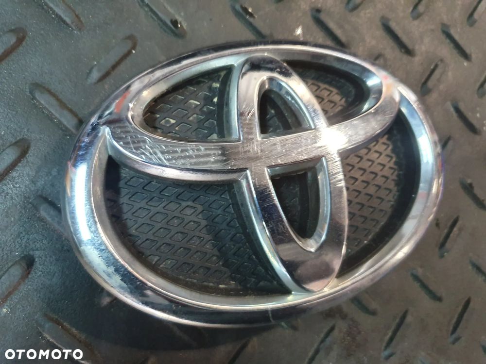 TOYOTA YARIS II LIFT 09-11 EMBLEMAT LOGO ZNACZEK 75311-0D030 - 2