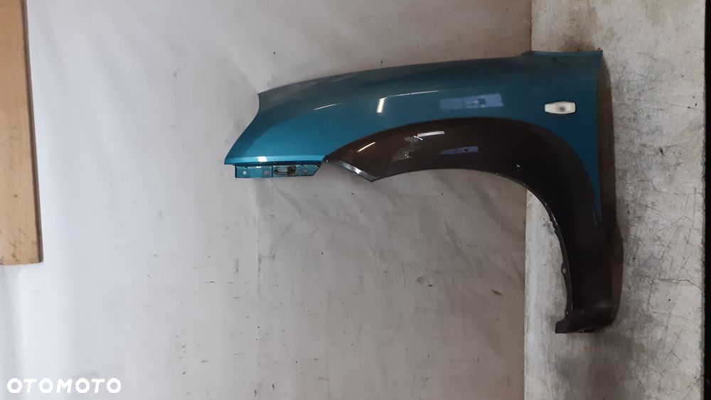 * Hyundai Tucson I 1 błotnik lewy przedni przód MORSKI KOLOR HE - 1