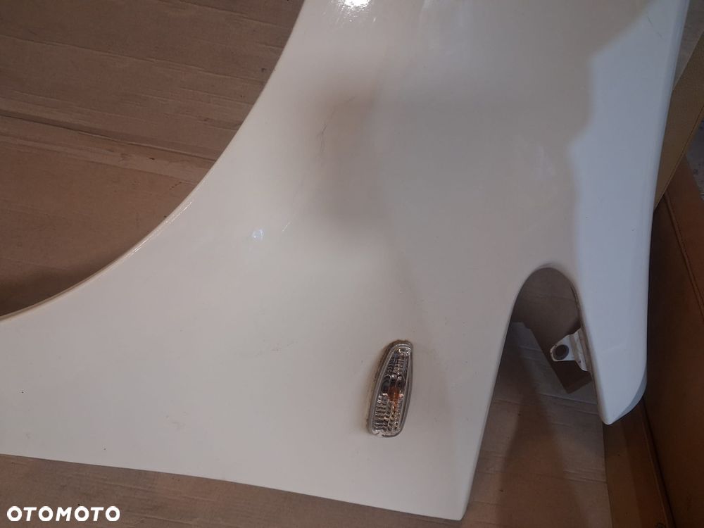 Błotnik KIA RIO III LIFT  lewy  biały kol UD - 6