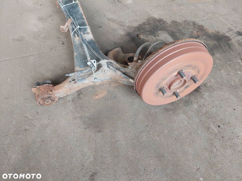BELKA OŚ ZAWIESZENIA TYŁ BĘBNY Z ABS TOYOTA YARIS I ID: 238000 - 5