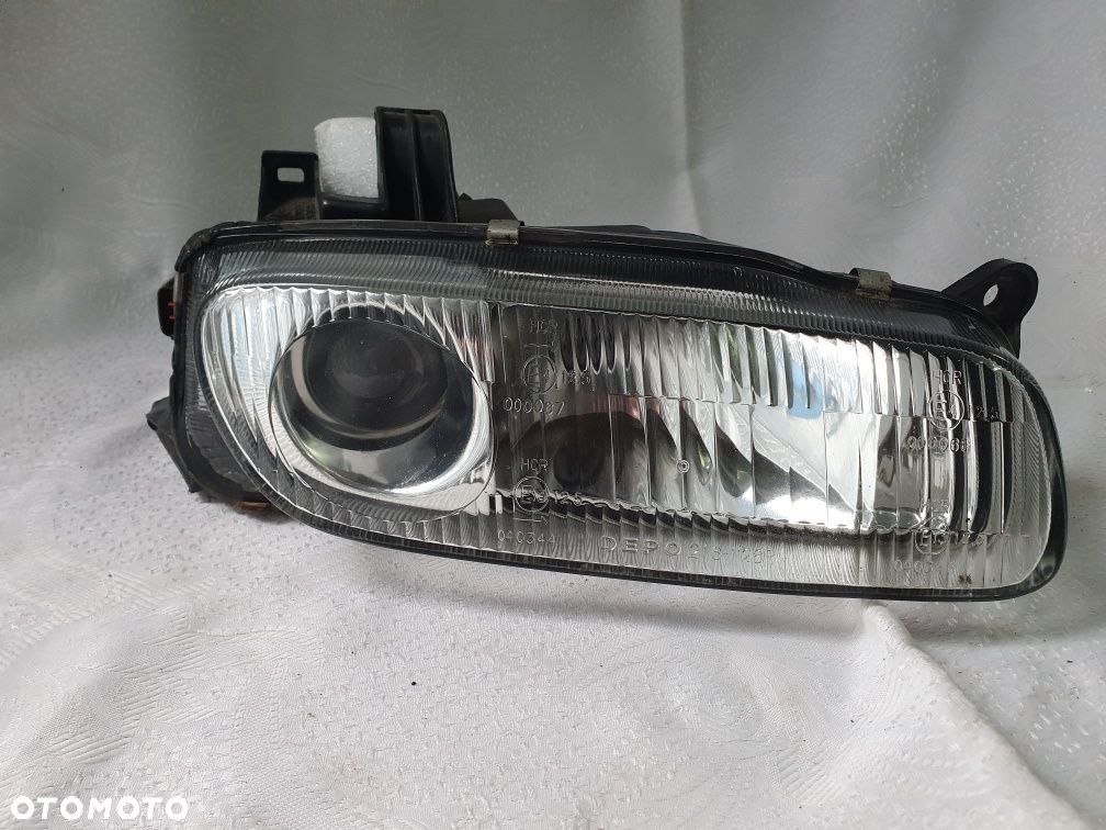 Lampa prawa mazda 323 Europa Soczewka - 1