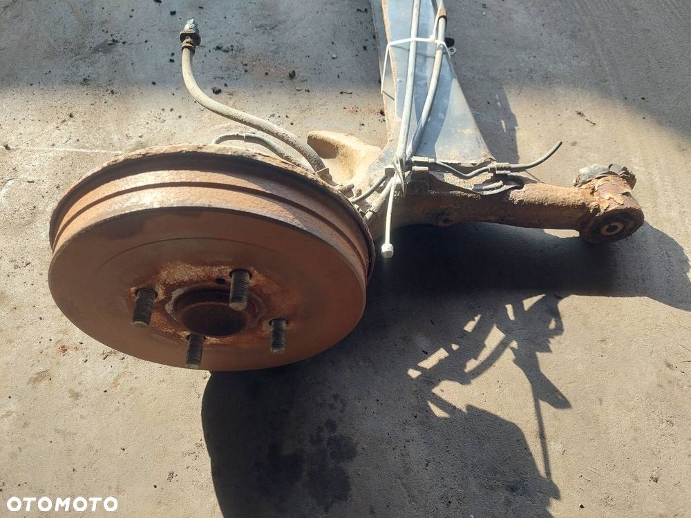 BELKA OŚ ZAWIESZENIA TYŁ BĘBNY Z ABS TOYOTA YARIS I ID: 238000 - 4