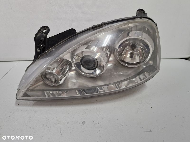 OPEL CORSA C LIFT LAMPA LEWY PRZÓD LEWA PRZEDNIA REFLEKTOR SOCZEWKA EU 13100535 - 1