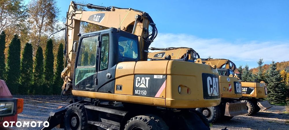 Caterpillar M315D rok 2010r podpory, chwytak obrotowy - 1