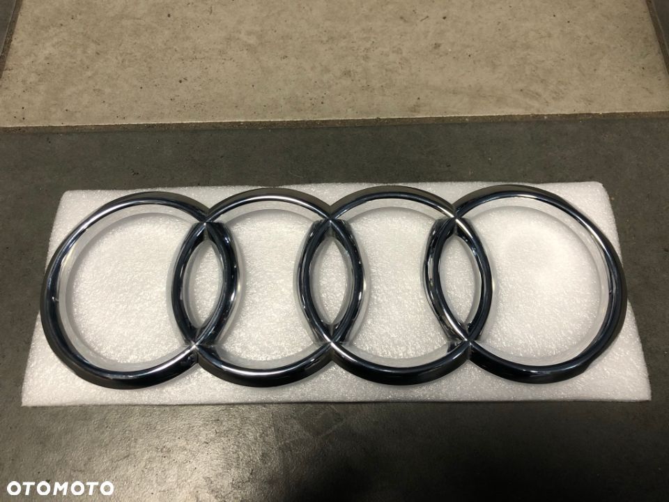 EMBLEMAT ZNACZEK LOGO AUDI Q7 PRZÓD 4M0853605 - 1