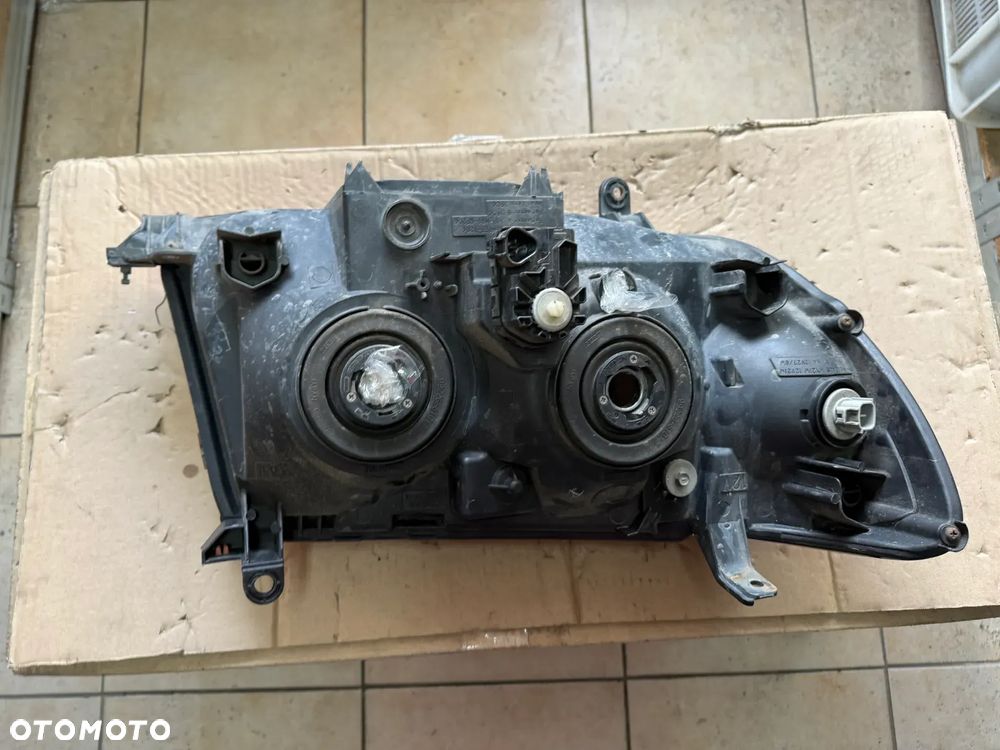 Reflektor / lampa przód przednia lewa Toyota Land Cruiser 100 LC100  - oryginalna - 2