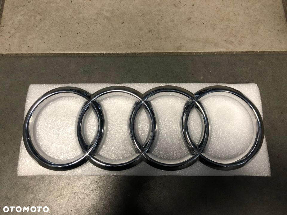 EMBLEMAT ZNACZEK LOGO AUDI Q7 PRZÓD 4M0853605 - 2
