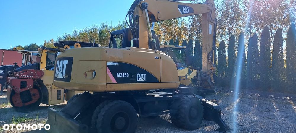 Caterpillar M315D rok 2010r podpory, chwytak obrotowy - 3