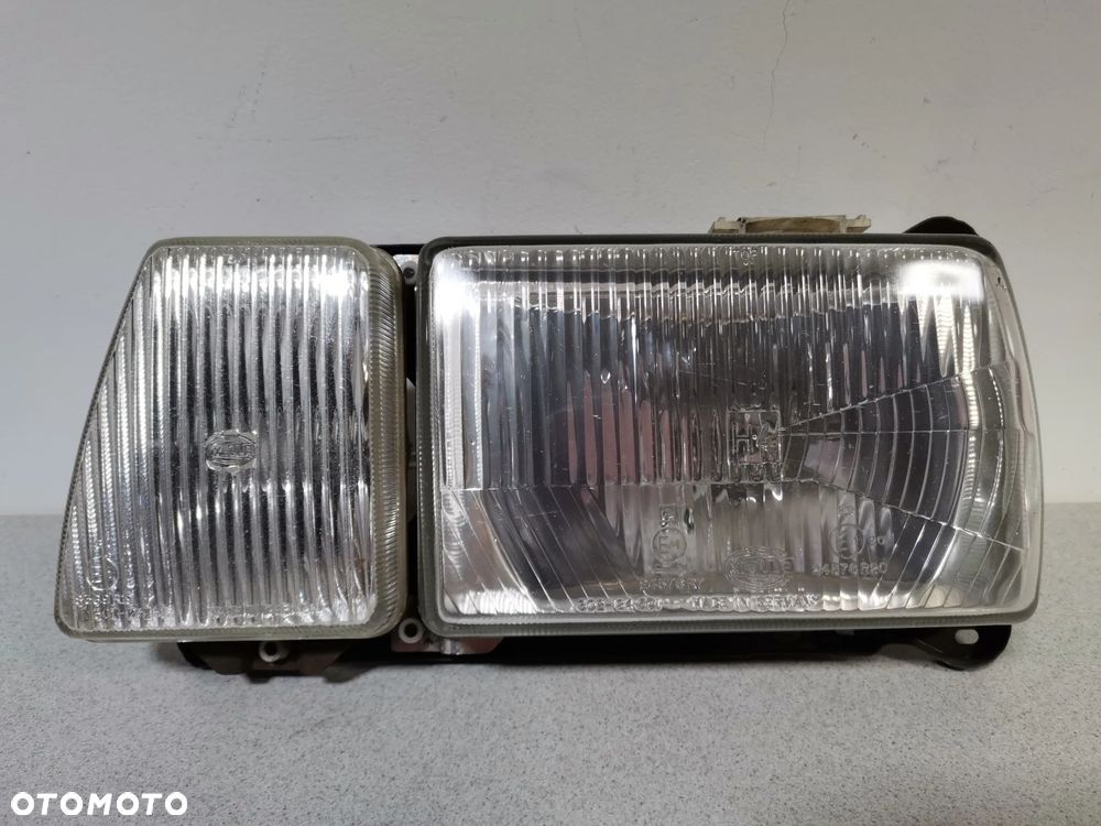 Lampa Reflektor LEWY VOLKSWAGEN PASSAT B2 80-88 HELLA Oryginał