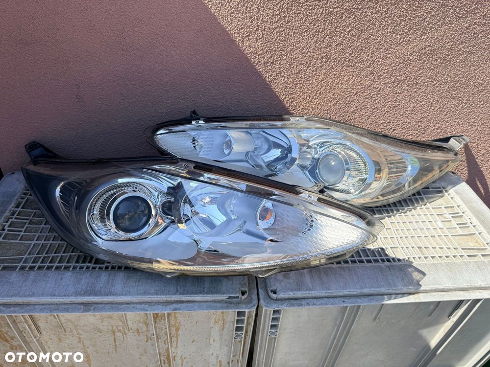 Lampa przednia FORD FIESTA MK7 SOCZEWKI KOMPLET EUROPA ORYGINALNE HELLA - 1