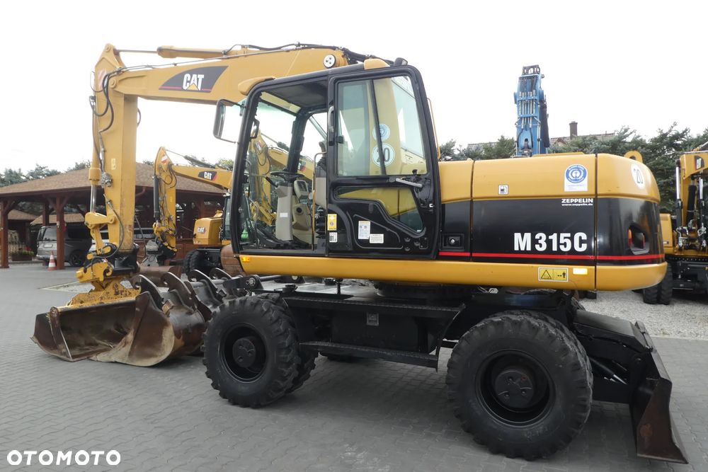 Caterpillar M315C Z NIEMIEC TRZY ŁYZKI - 26