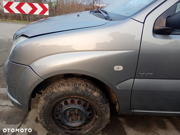 SUZUKI IGNIS II 04-08 ZCD błotnik lewy przedni przód