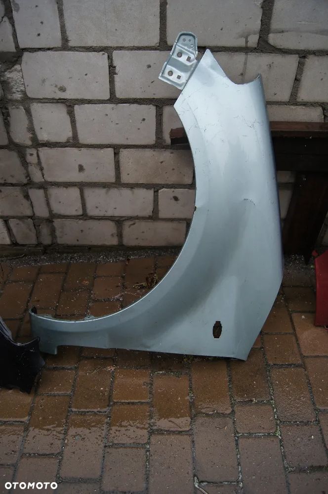 SUZUKI SX4 06-12 BŁOTNIK PRZEDNI LEWY - 1