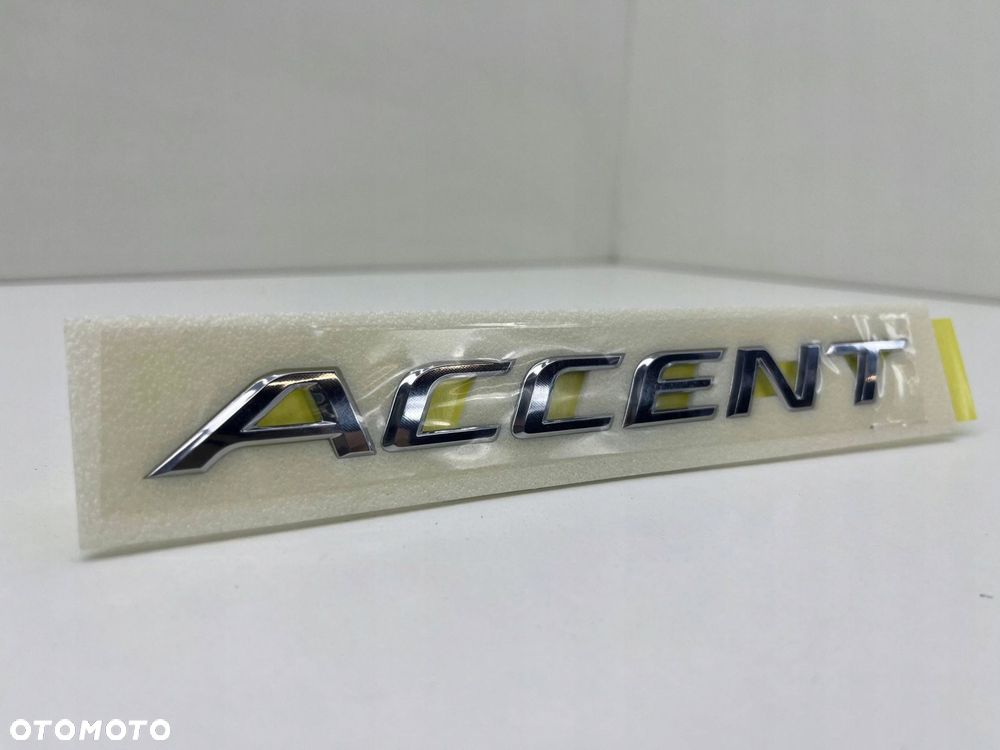 HYUNDAI ACCENT ZNACZEK EMBLEMAT LITERY MODELU 86311-H5000 - 2