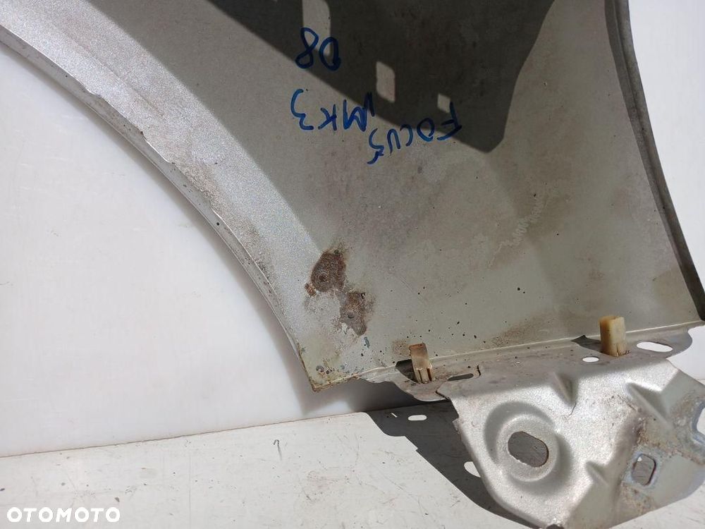 BŁOTNIK PRZÓD PRZEDNI LEWY SREBRNY FORD FOCUS MK3 III KOD LAKIERU 08 OB - 7