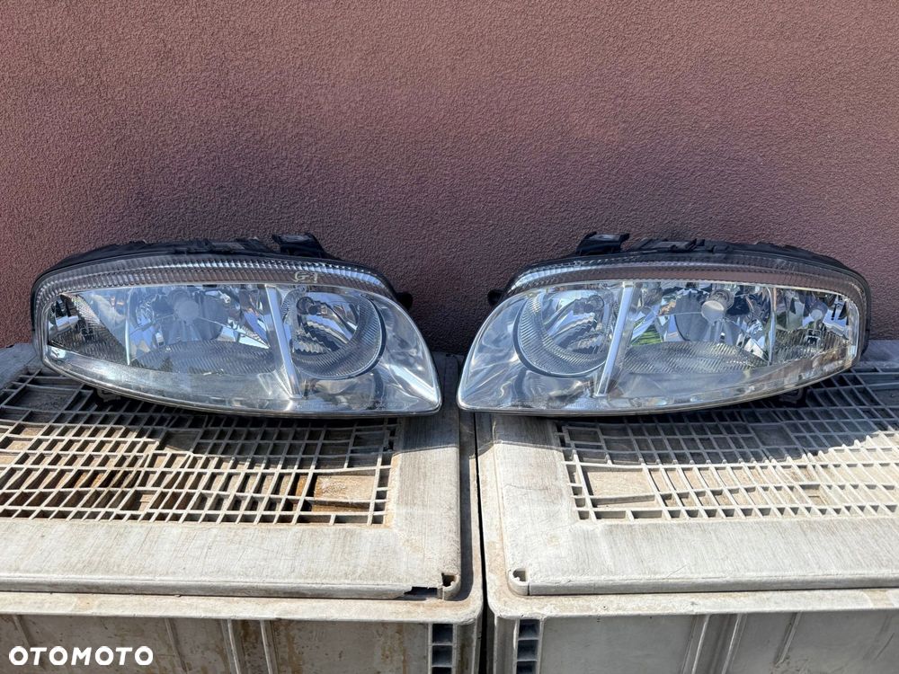 Lampa przednia ALFA ROMEO GT ZWYKŁE KOMPLET EUROPA ORYGINALNE AL - 1