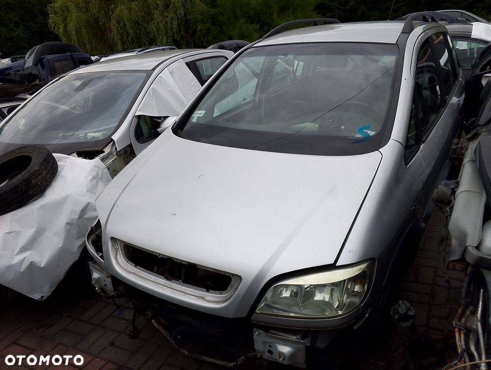 Opel Zafira A (99-03r.) 1.6 B 100KM. Silnik X16XEL  (Z16XE) Skrzynia MG4 (F17C419) lakier Z147 (82L). Cały na części. GWARANCJA !!!  Przód Tył Zestaw Komplet Drzwi Klapa Zderzak Błotnik Maska Grill Atrapa Szyba Pas Lampa Lusterko Boczki Fotel Kanapa Kokpit Deska Rozdzielcza Przełącznik Włącznik Sterownik Przewody Wiązka Instalacja Moduł Komputer Czujnik Listwa Pompa Alternator Wtryski Głowica Rozrusznik Kompresor Sprzęgło Dwumas Silnik Skrzynia ABS Klimatyzacji Paliwa Wspomagania Kolektor Turbina Przepustnica Zawór Chłodnica Koło Hak Belka Sanki Zawieszenie Mcpherson Półoś Amortyzator Wydech Tłumik Zacisk Most - 2