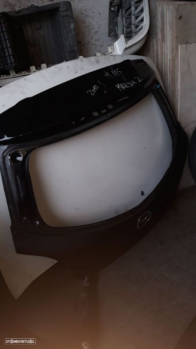 MAZDA 2 2010 TAMPA DE MALA M115 - 1