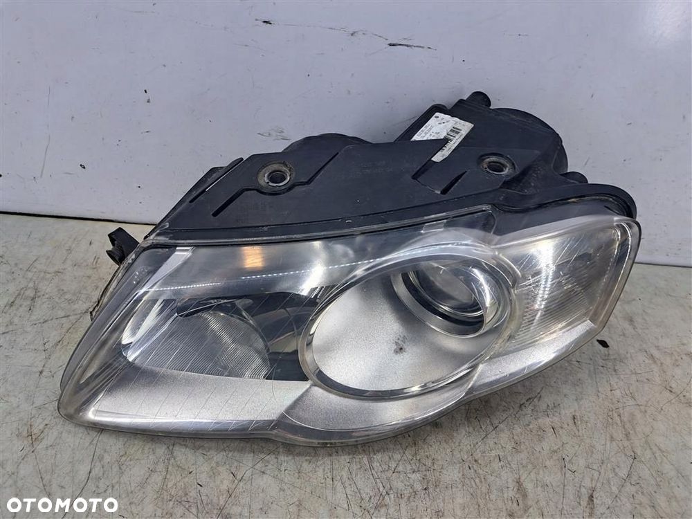 Reflektor lampa przód lewa VW Passat B6 05-09 PRZED FL HELLA 3C0941005J 1EL247014-01 - 1