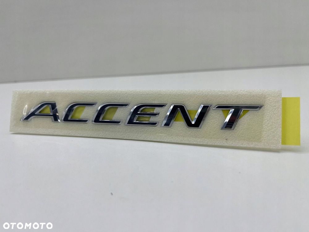 HYUNDAI ACCENT ZNACZEK EMBLEMAT LITERY MODELU 86311-H5000 - 3