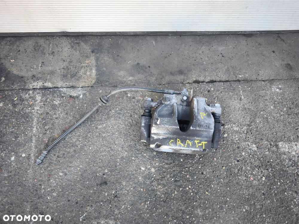 Zacisk lewy przód VW Crafter II Man tge przód napęd 2016-2025