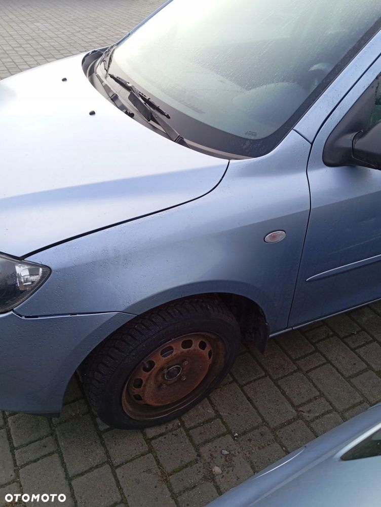 MAZDA 2 II BŁOTNIK LEWY PRZEDNI PRZOD 27P - 1