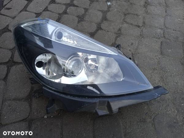 REFLEKTOR PRAWY RENAULT CLIO III 05-09 7701061076 USZKODZONE SZKŁO - 2